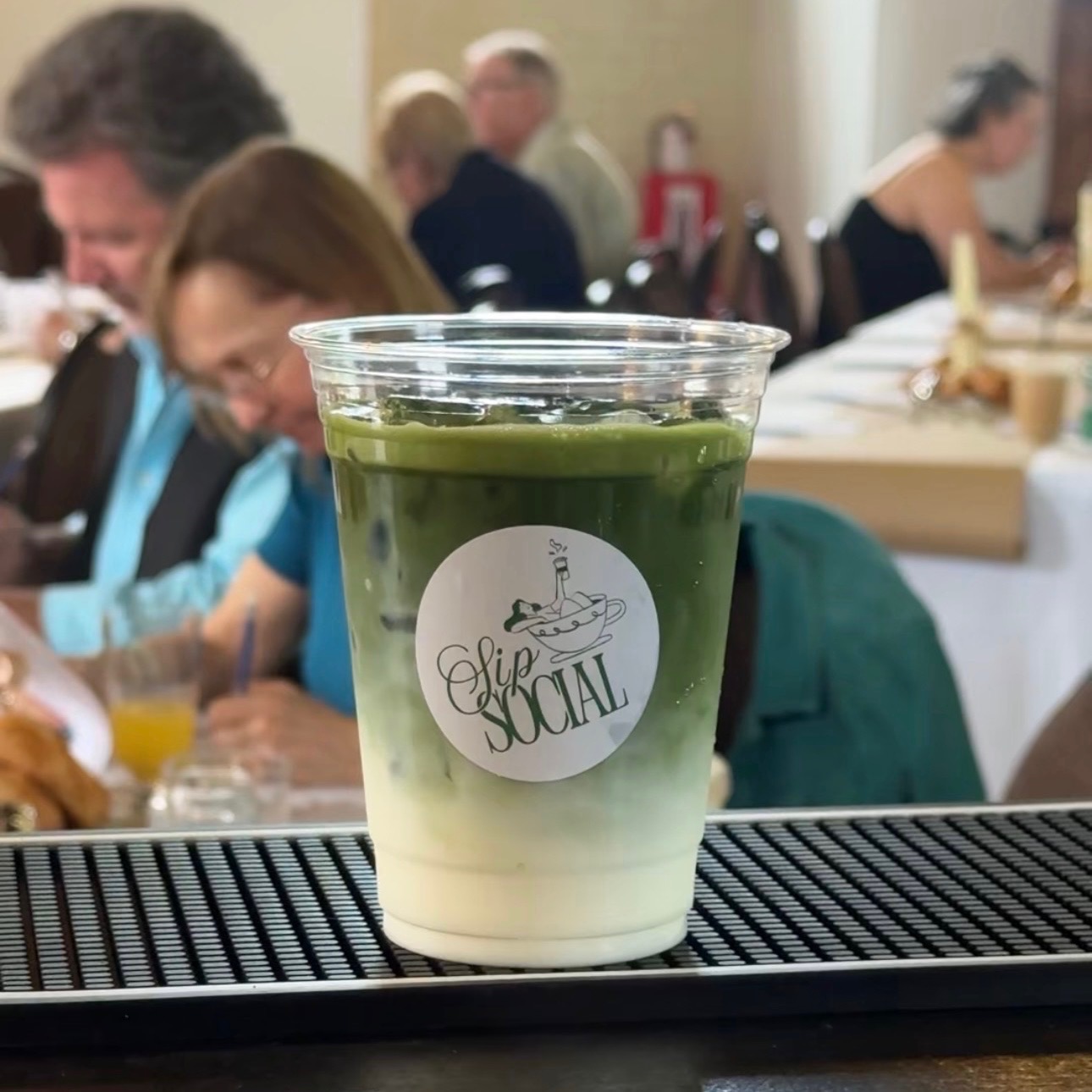 Layered iced matcha latte served at a brunch event